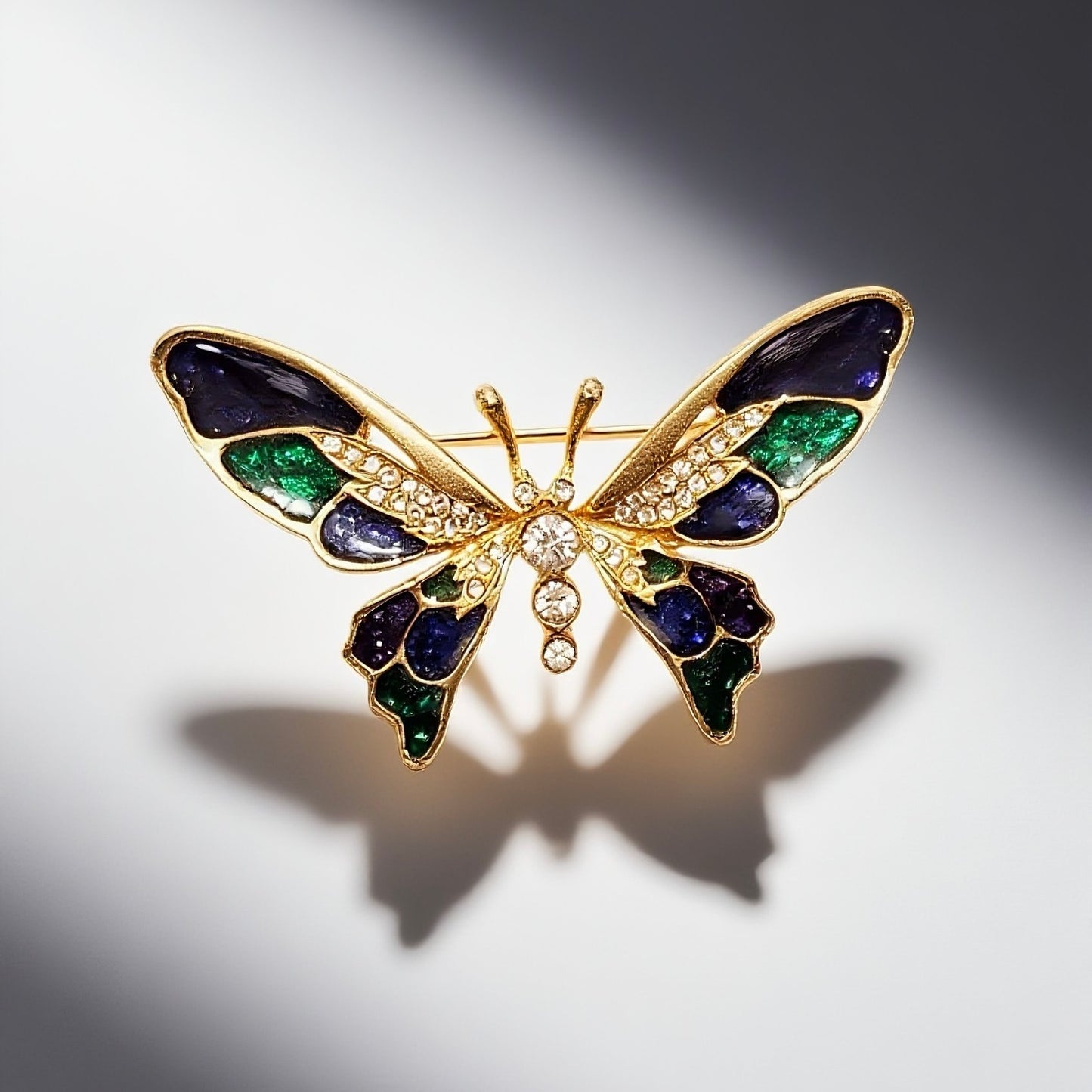 Vintage French 60s butterfly enamel brooch with blue and green patchwork and diamond inlay featuring a vintage court style